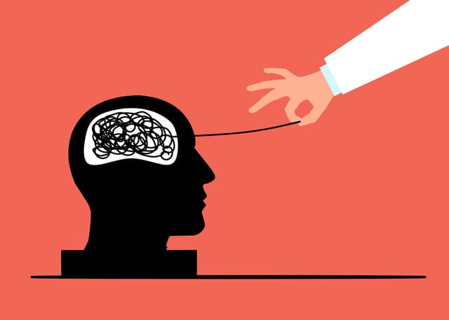 A brain with thread being pulled to showing a therapist unravelling problems